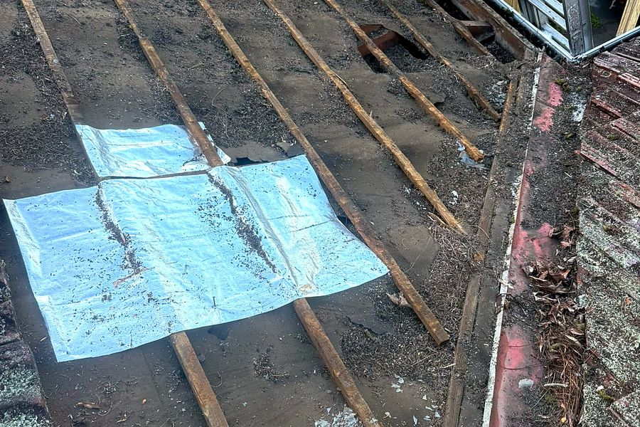 Foil laid over holes in old roof sarking as an earlier patch, Castle Hill