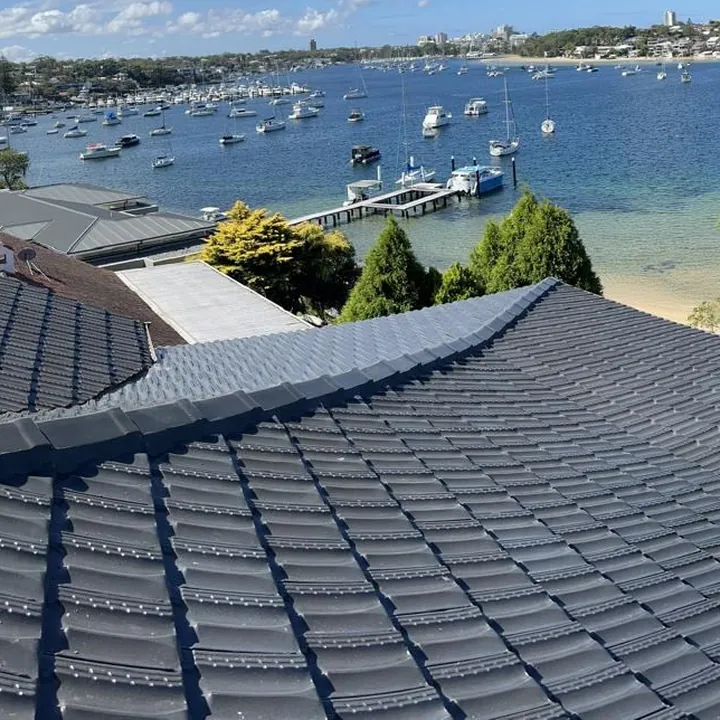 A finished tile roof restoration with freshly coated charcoal tiles