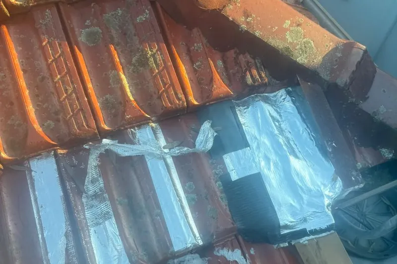 Foil tape and sealant someone else had stuck over the roof tiles
