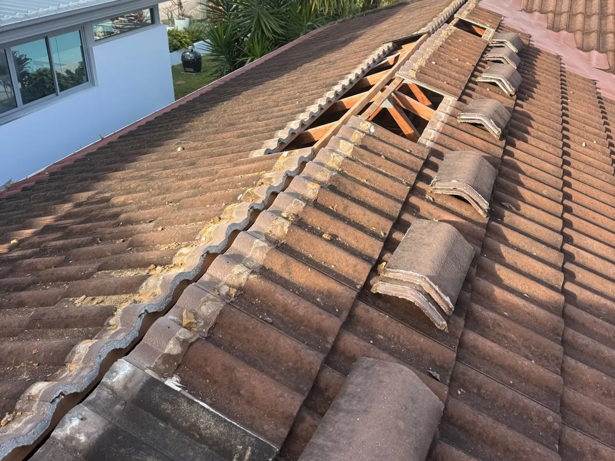 Ridge capping lifted to show failed cement bedding underneath